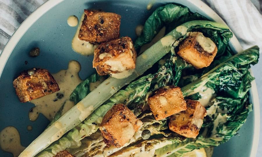 Grilled vegan caesar salad with crispy tofu croutons